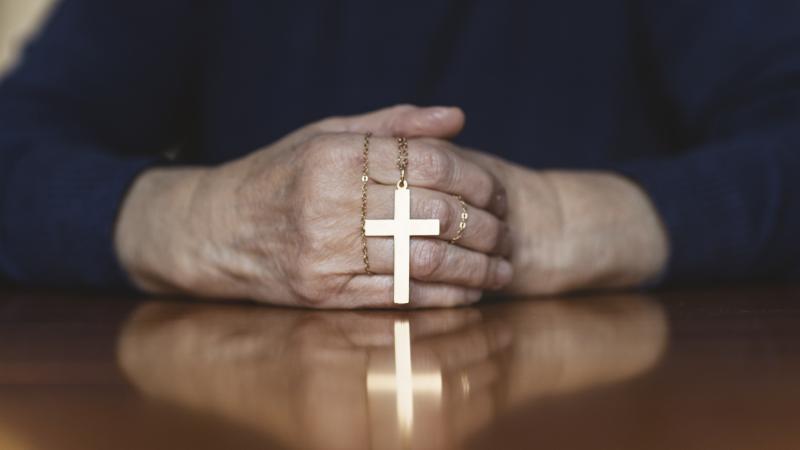  Catholic with cross and hands folded 