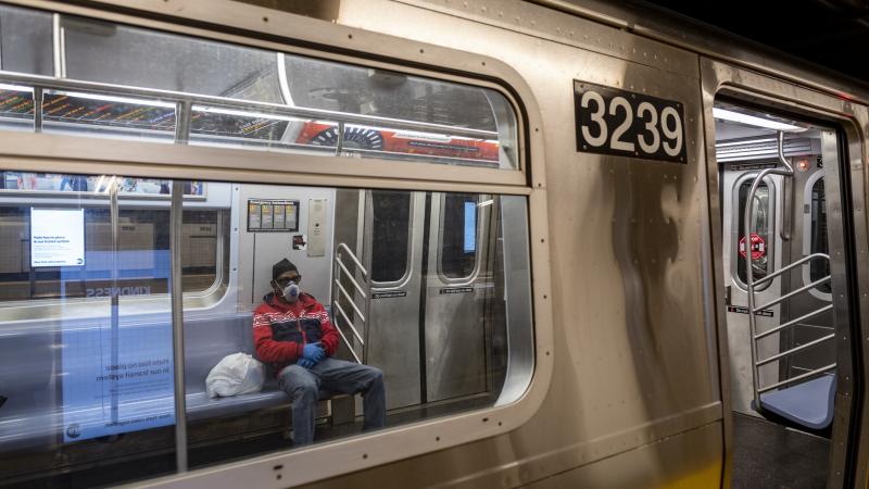 A masked commuter on a New York City subway
