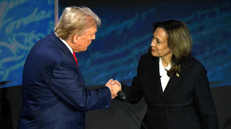 US Vice President and Democratic presidential candidate Kamala Harris (R) shakes hands with former US President and Republican presidential candidate Donald Trump during a presidential debate at the National Constitution Center in Philadelphia, Pennsylvania, on September 10, 2024.
