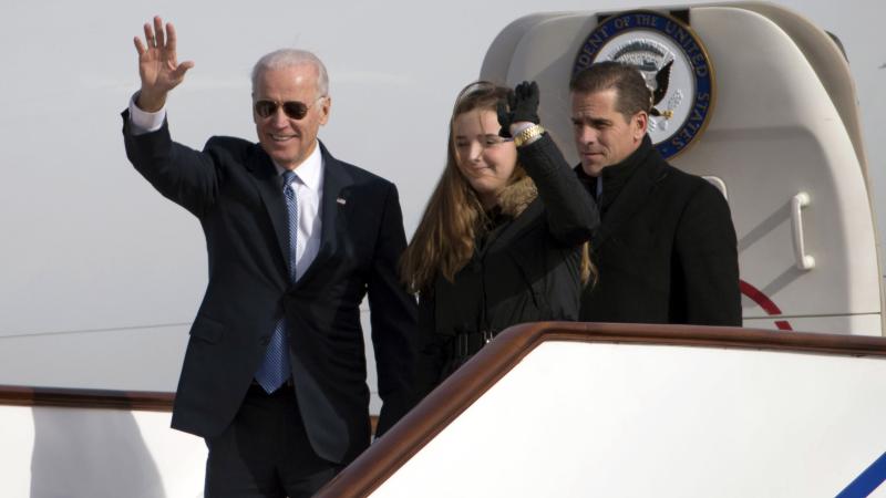 BEIJING, CHINA - DECEMBER 04: U.S. Vice President Joe Biden waves as he walks out of Air Force Two with his granddaughter Finnegan Biden and son Hunter Biden (R) on December 4, 2013 in Beijing, China.
