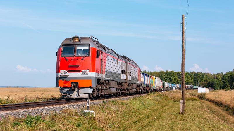 Powerful diesel locomotive with freight train